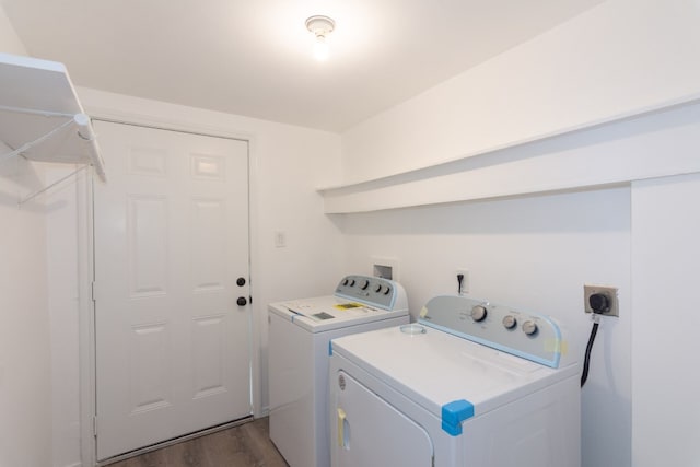 clothes washing area with washer and dryer and dark hardwood / wood-style flooring