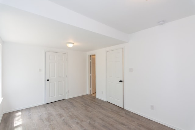 spare room with light hardwood / wood-style floors