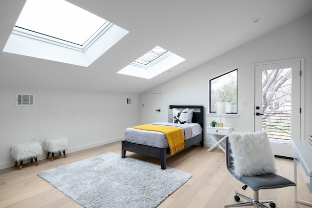 bedroom featuring lofted ceiling and light wood-type flooring