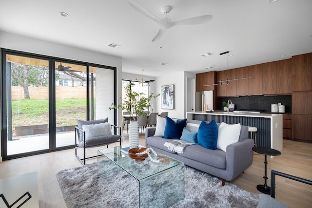 living room featuring light hardwood / wood-style floors and ceiling fan