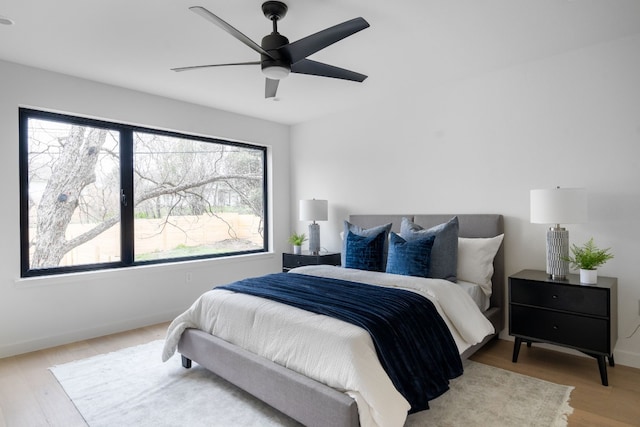 bedroom with ceiling fan and light wood-type flooring