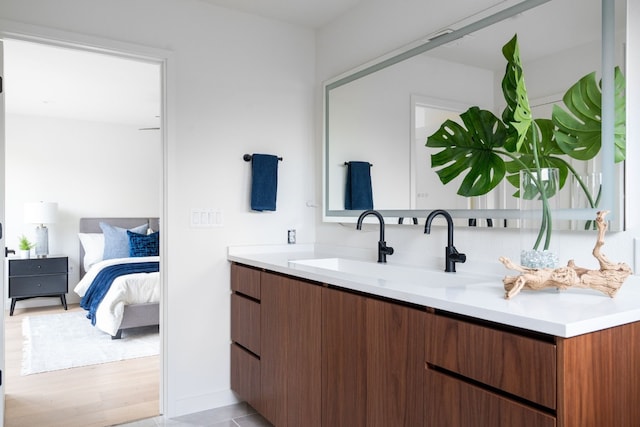 bathroom with hardwood / wood-style floors and vanity