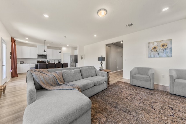 living room with light hardwood / wood-style floors