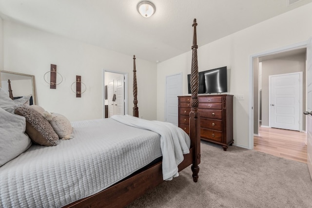 carpeted bedroom with connected bathroom