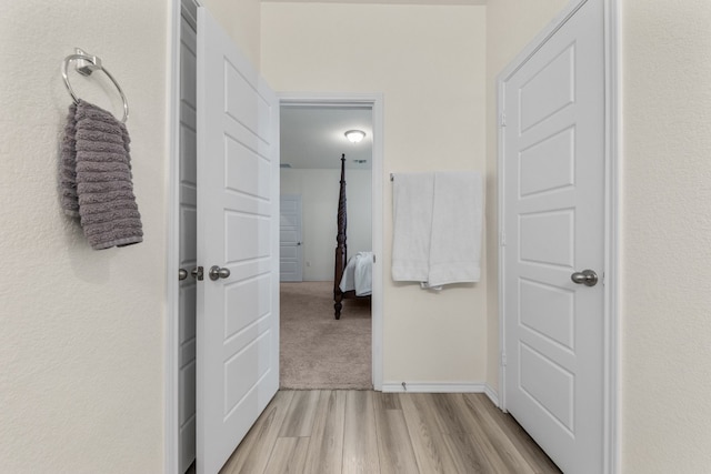 corridor with light hardwood / wood-style flooring