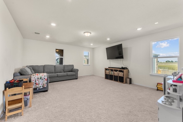 living room with a wealth of natural light and light colored carpet