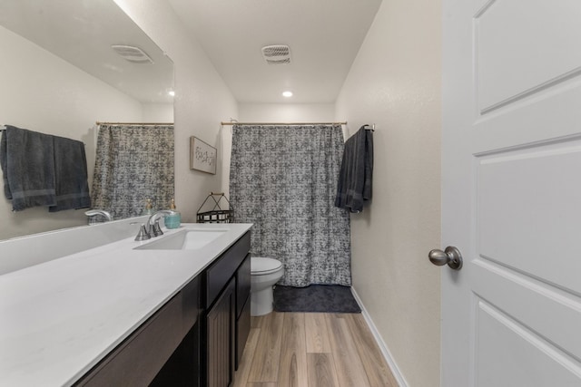 bathroom featuring a shower with shower curtain, vanity, hardwood / wood-style flooring, and toilet