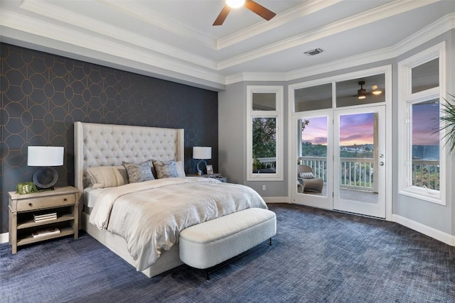 carpeted bedroom with ceiling fan, access to exterior, ornamental molding, and a tray ceiling