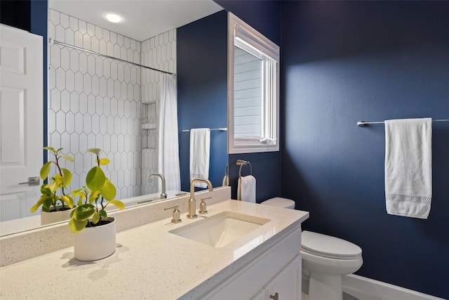 bathroom with vanity, curtained shower, and toilet