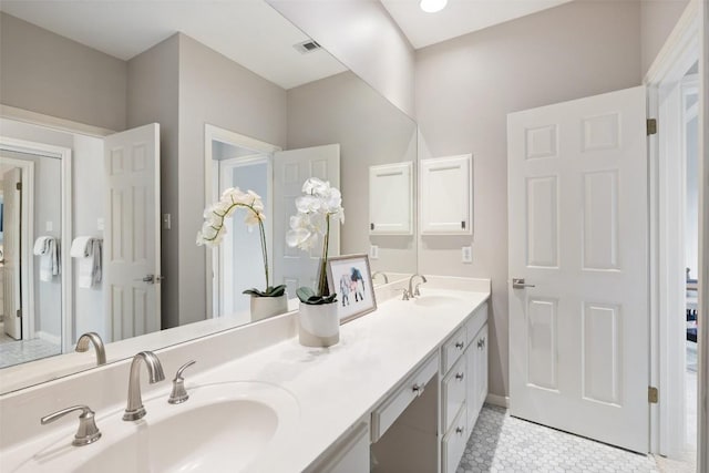 bathroom featuring tile patterned flooring and vanity