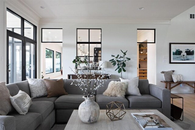 living room featuring hardwood / wood-style flooring and crown molding