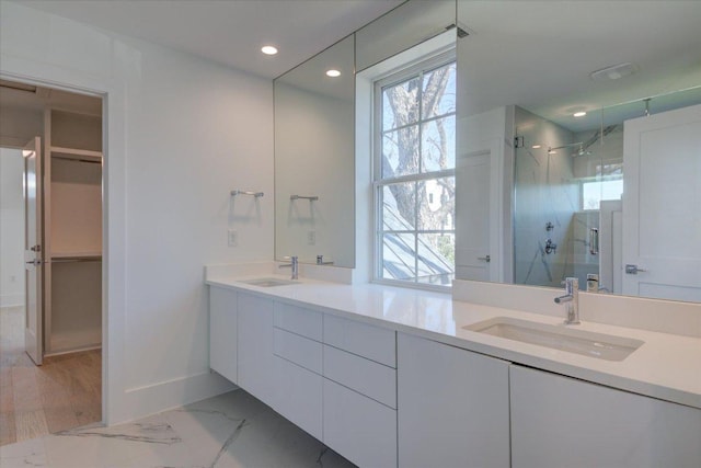 2618 E 4th St, Austin, TX 78702 - full bath featuring a stall shower, double vanity, recessed lighting, baseboards, and marble look tiles