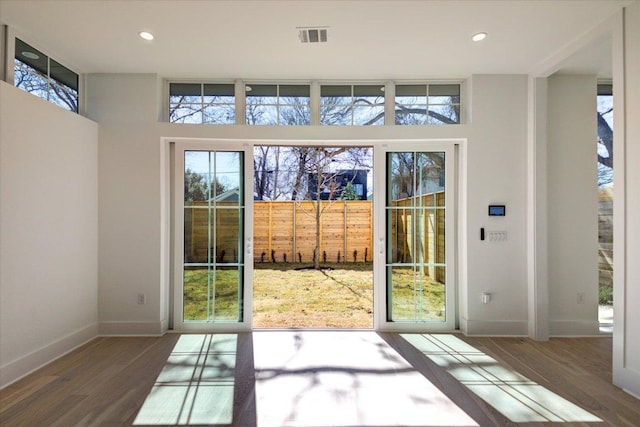 entryway featuring recessed lighting, visible vents, baseboards, and wood finished floors