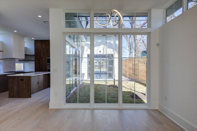 2618 E 4th St, Austin, TX 78702 - unfurnished dining area with a chandelier, light wood finished floors, baseboards, and recessed lighting