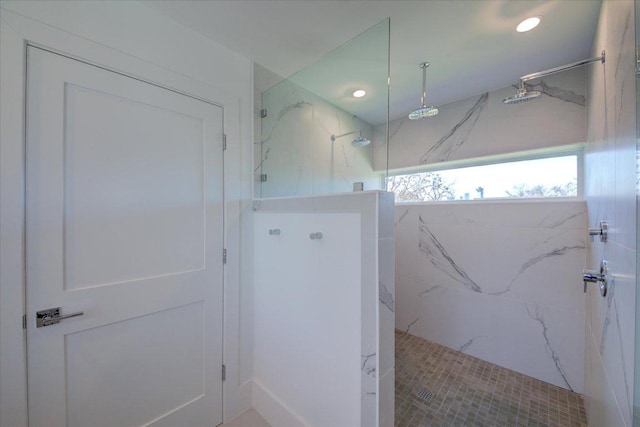 bathroom featuring a marble finish shower