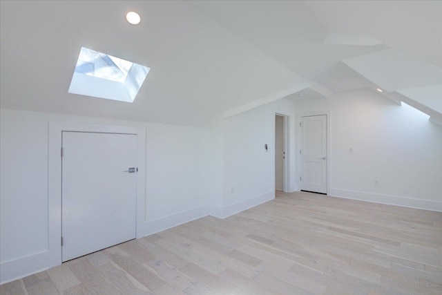 2618 E 4th St, Austin, TX 78702 - additional living space with a skylight, light wood-type flooring, vaulted ceiling, and baseboards