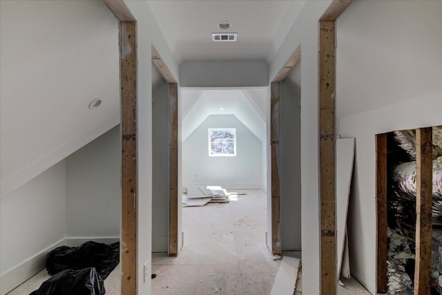 additional living space featuring lofted ceiling and visible vents