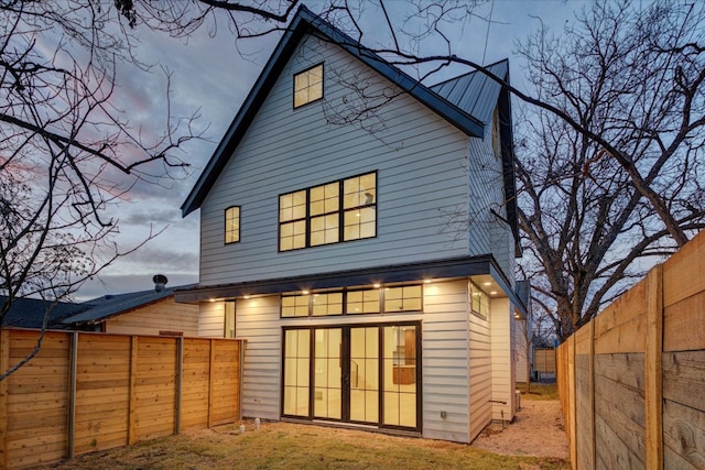 back of house with a fenced backyard