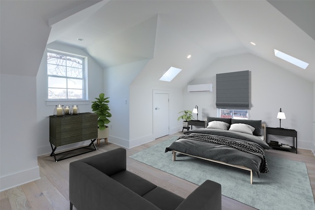 bedroom featuring light wood-type flooring, vaulted ceiling, baseboards, and a wall mounted AC