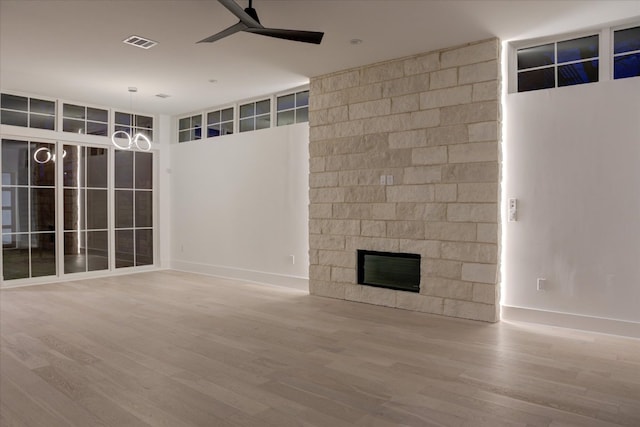 2618 E 4th St, Austin, TX 78702 - unfurnished living room featuring ceiling fan, wood finished floors, a fireplace, and baseboards