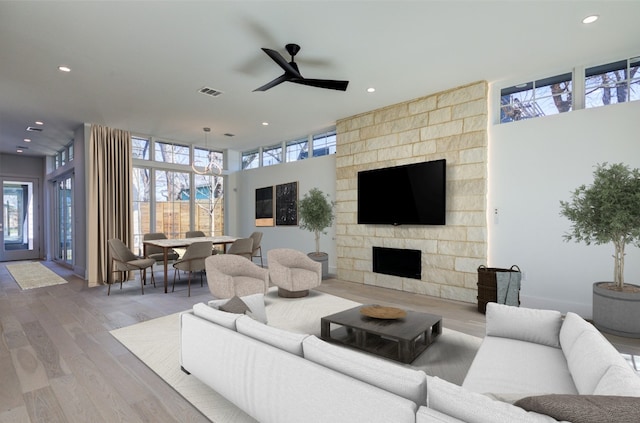 2618 E 4th St, Austin, TX 78702 - living area featuring plenty of natural light, a ceiling fan, recessed lighting, wood finished floors, and a fireplace