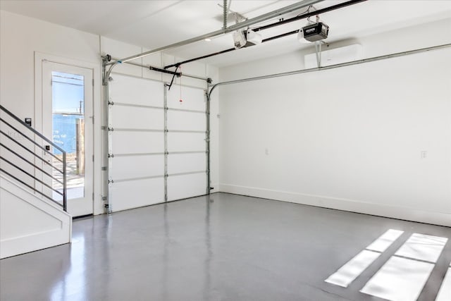 garage with baseboards and a garage door opener