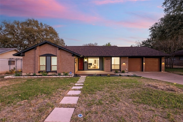 single story home with a yard and a garage