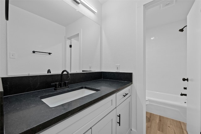 full bathroom with vanity, hardwood / wood-style flooring, toilet, and tub / shower combination