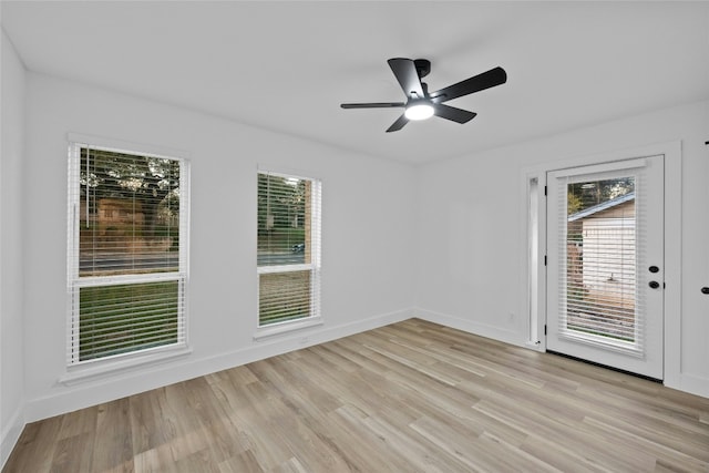 empty room with light hardwood / wood-style flooring and ceiling fan