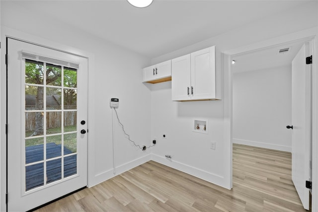 laundry room with electric dryer hookup, cabinets, gas dryer hookup, light hardwood / wood-style flooring, and washer hookup