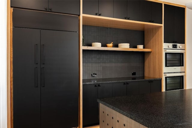 2114 Lawnmont Ave, Austin, TX 78756 - kitchen featuring double oven, tasteful backsplash, open shelves, and dark countertops