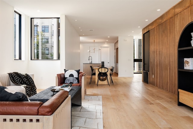 living room with sink and light hardwood / wood-style flooring