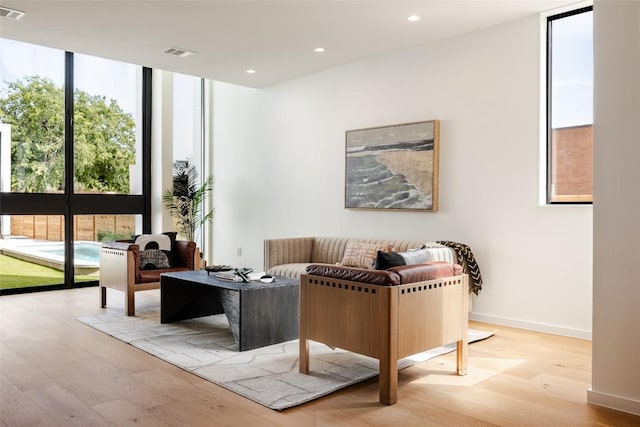2114 Lawnmont Ave, Austin, TX 78756 - living room with expansive windows, plenty of natural light, wood finished floors, and recessed lighting