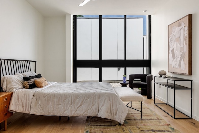 bedroom with ceiling fan and light hardwood / wood-style flooring