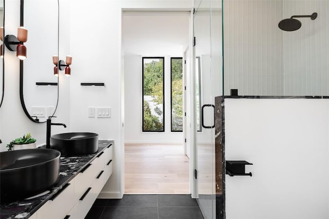2114 Lawnmont Ave, Austin, TX 78756 - full bath with a stall shower, tile patterned floors, and double vanity
