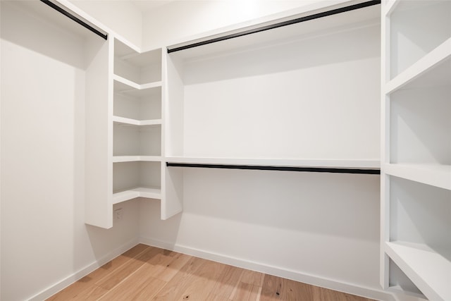 spacious closet with light hardwood / wood-style flooring