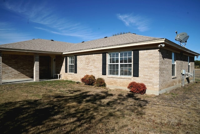 view of side of property with a yard