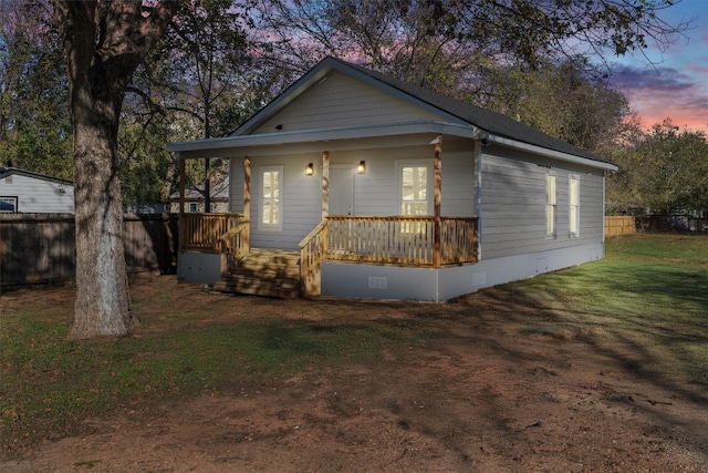 view of front of home with a lawn and a porch