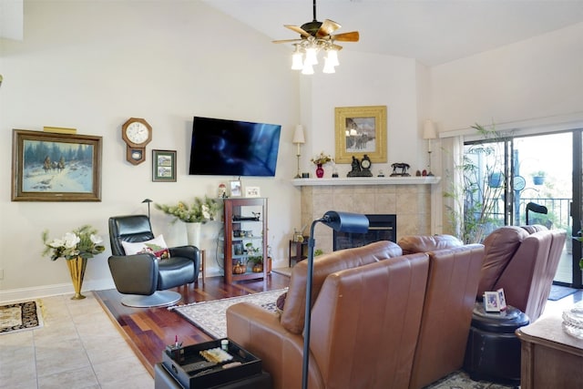 living room featuring ceiling fan, lofted ceiling, and light hardwood / wood-style flooring