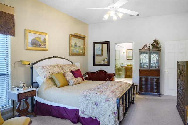 carpeted bedroom with connected bathroom and ceiling fan