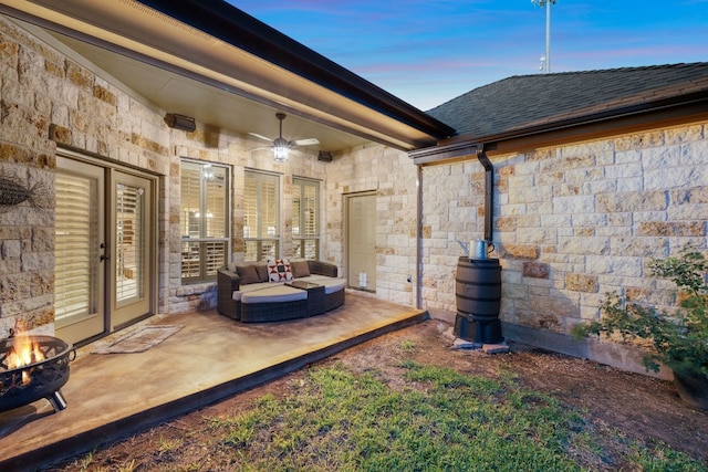 patio terrace at dusk with ceiling fan and an outdoor hangout area