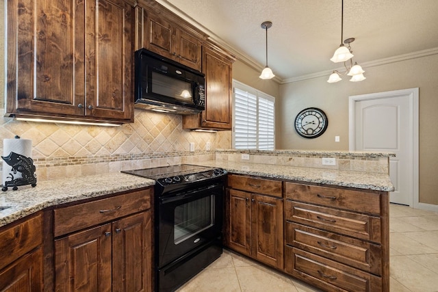 kitchen with light stone counters, pendant lighting, light tile patterned floors, black appliances, and ornamental molding