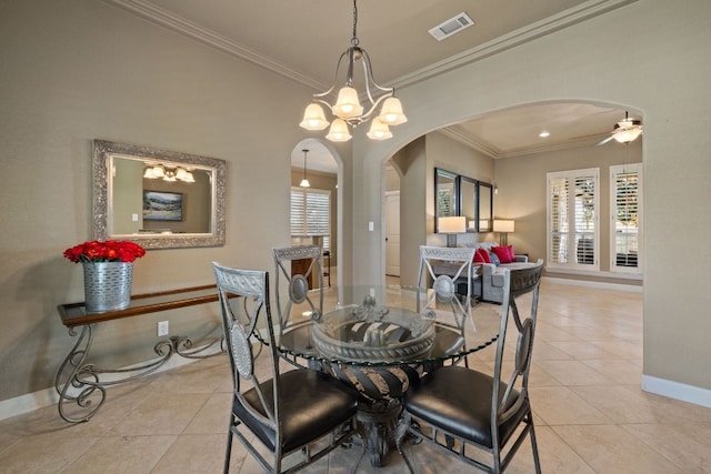 tiled dining space featuring ceiling fan with notable chandelier and ornamental molding