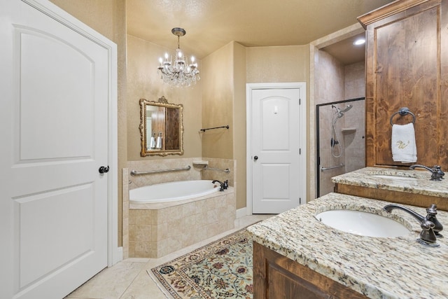 bathroom featuring tile patterned floors, a chandelier, a textured ceiling, shower with separate bathtub, and vanity