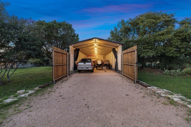 parking at dusk featuring a yard and a carport