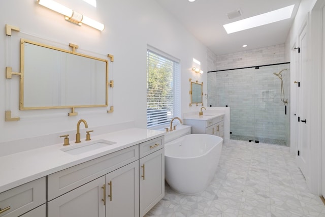 bathroom featuring vanity, separate shower and tub, and a skylight