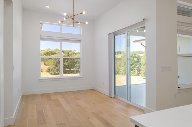 dining space featuring a chandelier, light hardwood / wood-style flooring, and a wealth of natural light