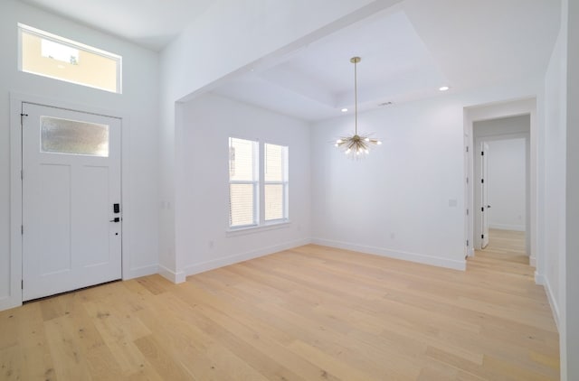 entryway with a notable chandelier and light hardwood / wood-style flooring