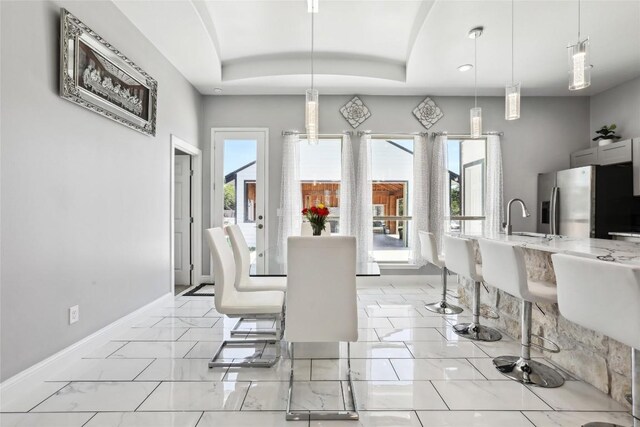 287 La Fortuna Dr, Del Valle, TX 78617 - dining room with baseboards, a raised ceiling, light marble finish flooring, and recessed lighting