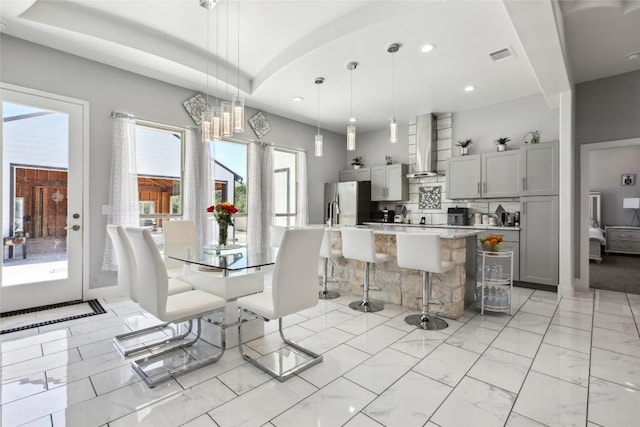 287 La Fortuna Dr, Del Valle, TX 78617 - dining area featuring light marble finish flooring, recessed lighting, and a chandelier